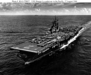 USS Shangri-La (CV-38) underway in the Pacific, crew paraded on flight deck, 17 August 1945, just after V-J Day. U.S. Navy photo.